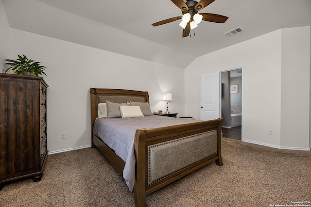 carpeted bedroom featuring vaulted ceiling, ensuite bath, and ceiling fan