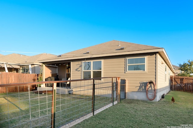 back of house with a lawn