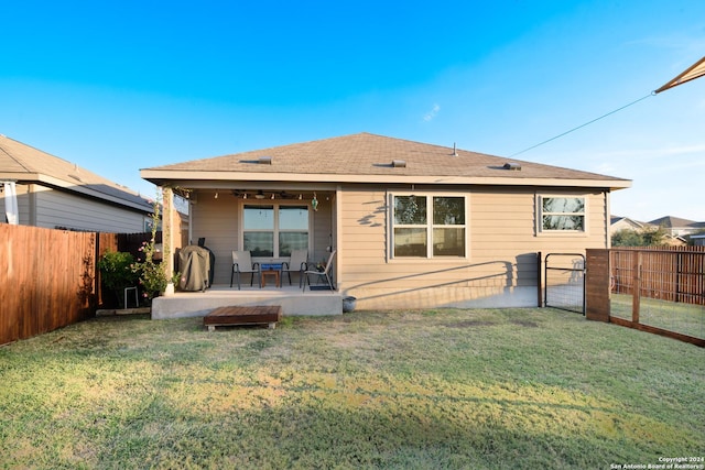 back of house featuring a yard and a patio