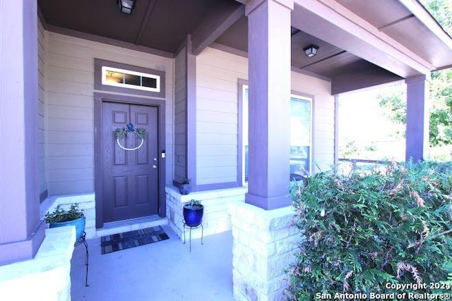 doorway to property featuring a porch