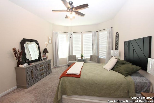 bedroom featuring ceiling fan and light colored carpet