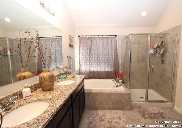 bathroom featuring vanity, separate shower and tub, and lofted ceiling