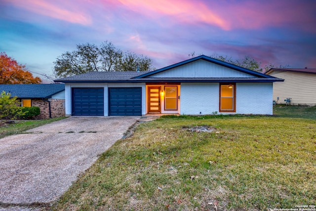 single story home with a yard and a garage