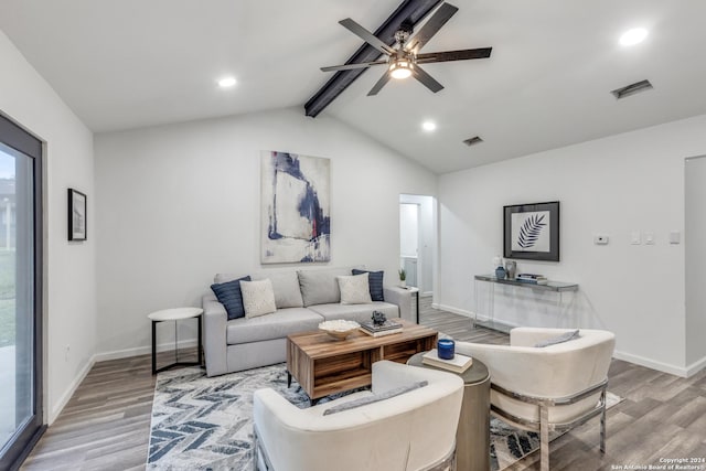 living room featuring vaulted ceiling with beams, light hardwood / wood-style flooring, and ceiling fan