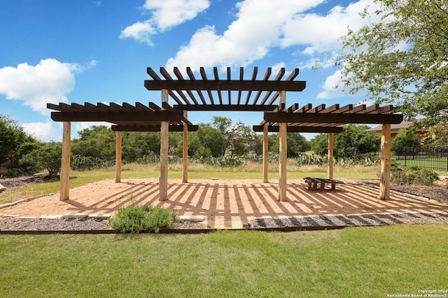 view of property's community with a lawn and a pergola