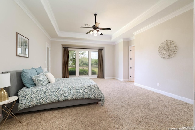 carpeted bedroom featuring ceiling fan, a raised ceiling, and ornamental molding