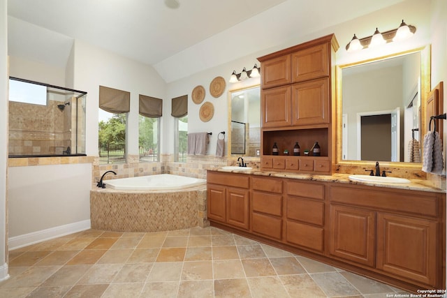 bathroom with vanity, independent shower and bath, and vaulted ceiling