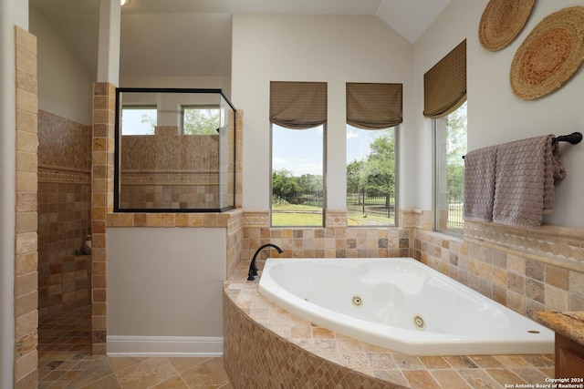 bathroom featuring tile patterned floors, separate shower and tub, and vaulted ceiling