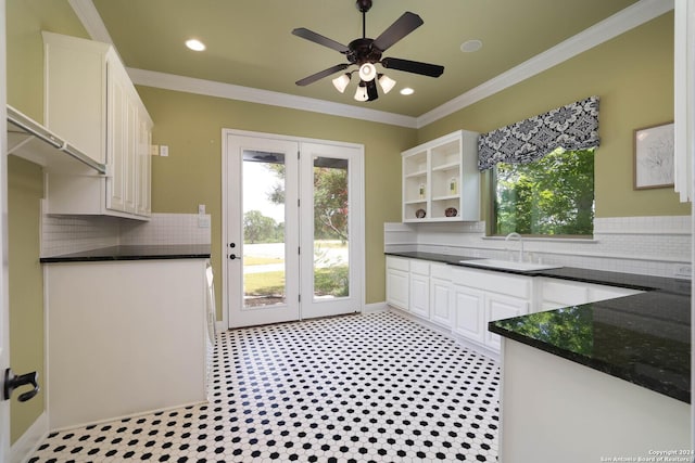 kitchen featuring white cabinets, sink, and crown molding