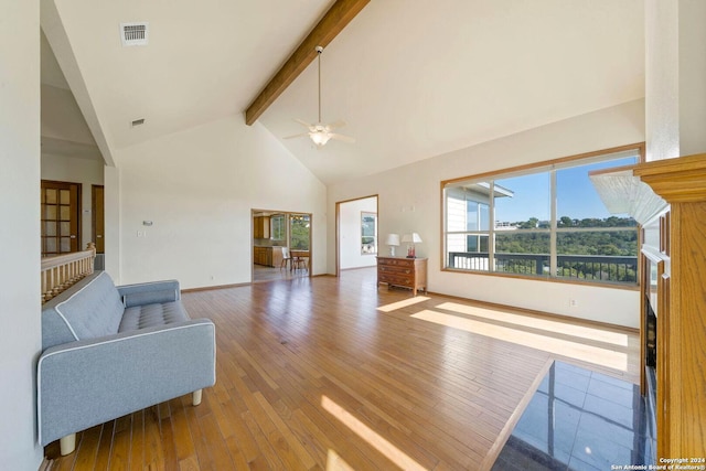 living room with ceiling fan, beam ceiling, wood-type flooring, and high vaulted ceiling