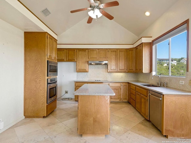 kitchen with decorative backsplash, a center island, stainless steel appliances, and sink