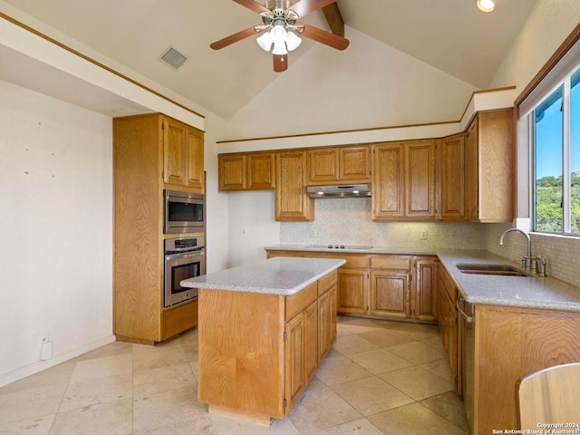 kitchen featuring backsplash, stainless steel appliances, ceiling fan, sink, and a center island