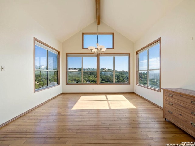 unfurnished sunroom featuring lofted ceiling with beams and an inviting chandelier