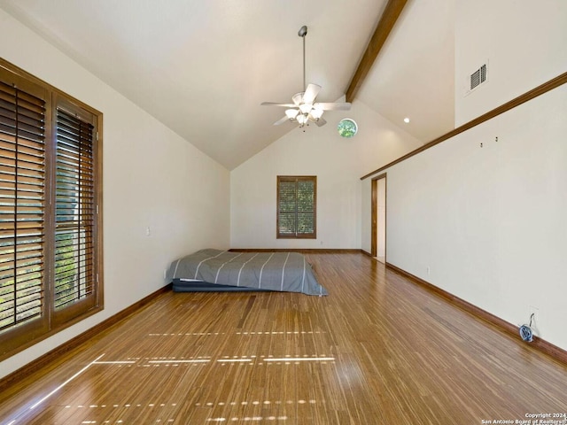 unfurnished bedroom featuring beamed ceiling, hardwood / wood-style flooring, ceiling fan, and high vaulted ceiling