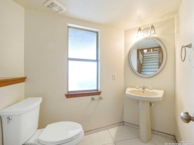 bathroom featuring tile patterned flooring and toilet