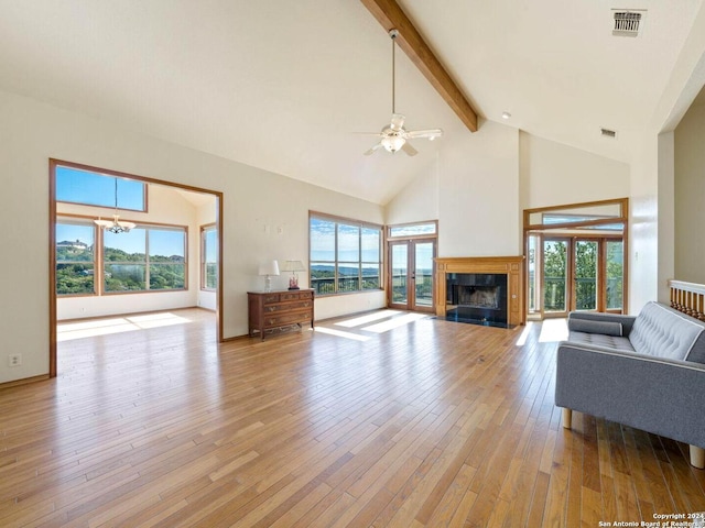 living room with beam ceiling, high vaulted ceiling, light hardwood / wood-style floors, and ceiling fan with notable chandelier