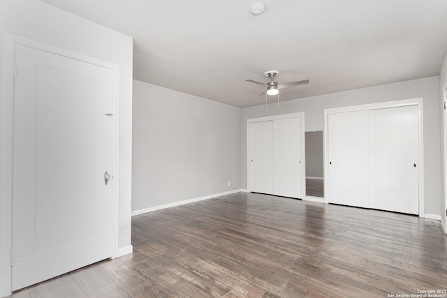 939 Avant Ave, San Antonio, TX 78210 - unfurnished bedroom with two closets, wood finished floors, and a ceiling fan