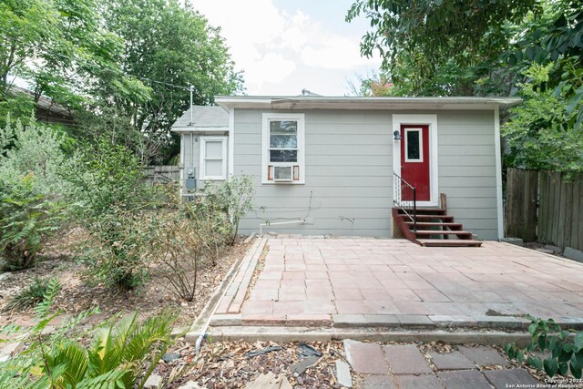 view of front of home with cooling unit and a patio