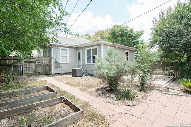 back of house featuring central air condition unit