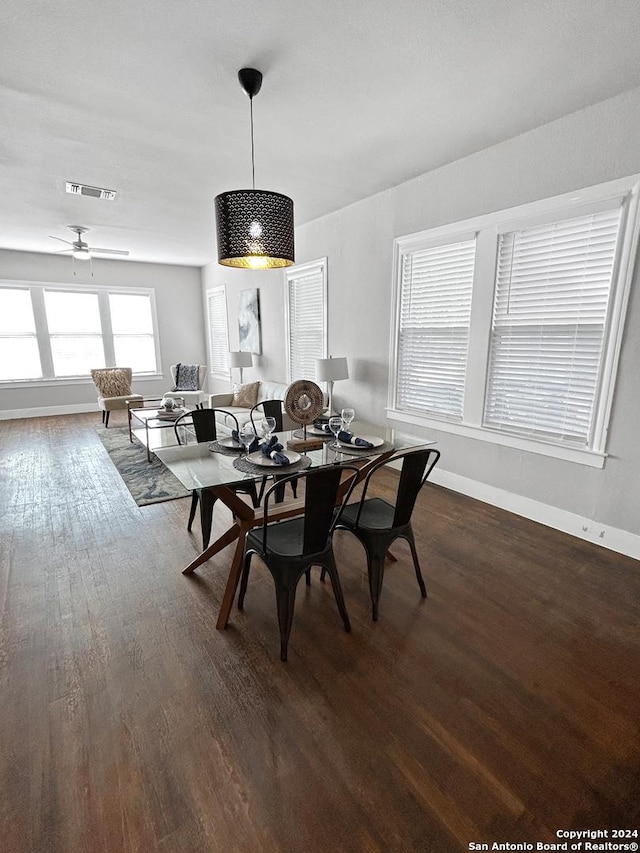 dining room featuring dark hardwood / wood-style flooring and ceiling fan