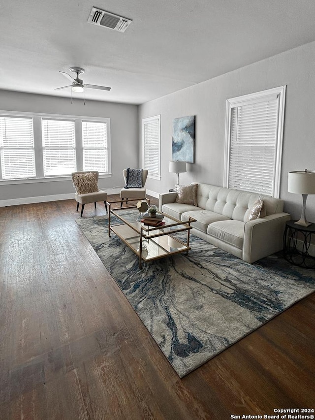 living room featuring ceiling fan and hardwood / wood-style flooring