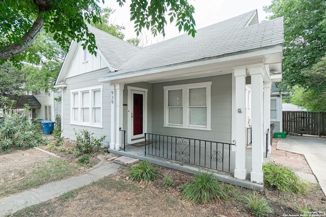 939 Avant Ave, San Antonio, TX 78210 - view of front of home with a porch, roof with shingles, and board and batten siding