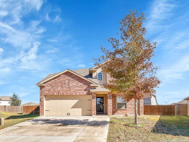 view of front of property featuring a garage and a front lawn