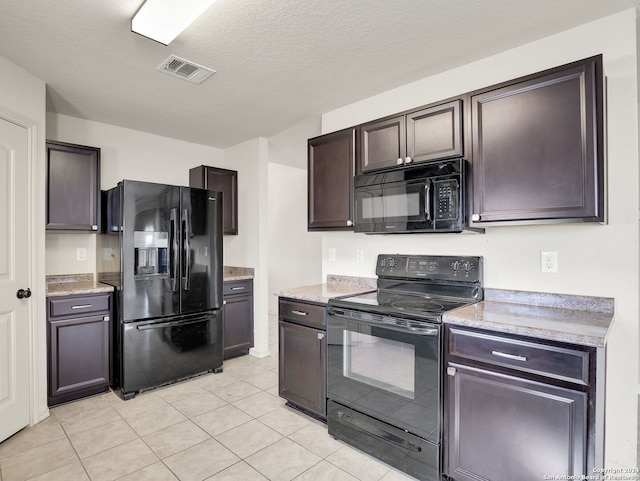 kitchen featuring dark brown cabinets, light tile patterned floors, black appliances, and a textured ceiling