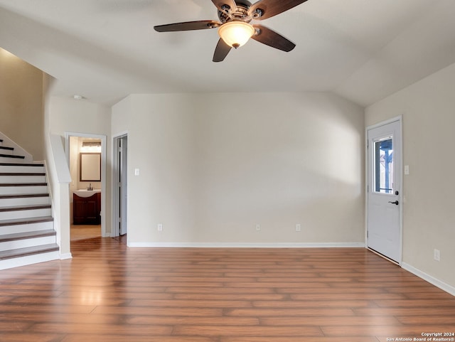 unfurnished living room with dark hardwood / wood-style floors, ceiling fan, and lofted ceiling