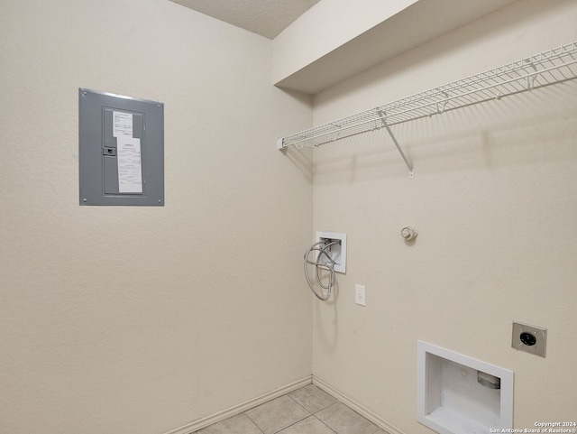 clothes washing area featuring hookup for an electric dryer, electric panel, gas dryer hookup, hookup for a washing machine, and light tile patterned flooring