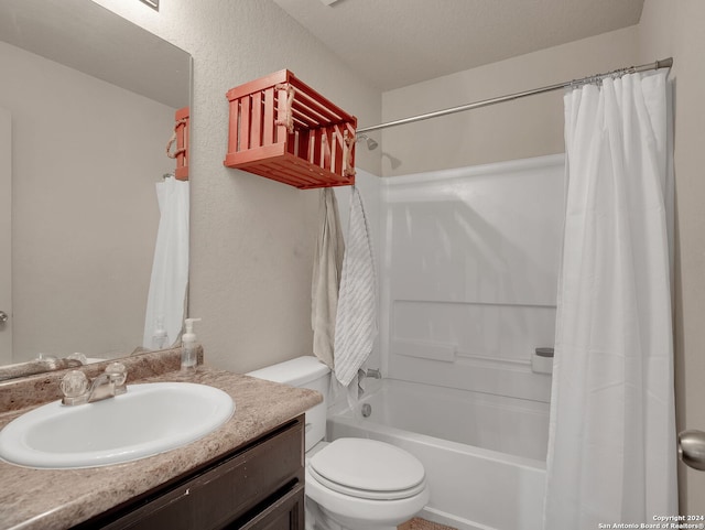 full bathroom featuring shower / bath combo with shower curtain, vanity, a textured ceiling, and toilet