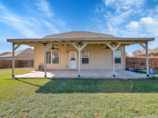 back of property featuring a yard and a patio area