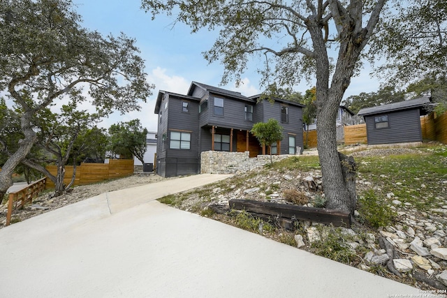 view of front of home featuring an outdoor structure and fence