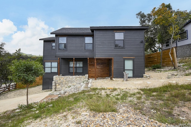 view of front of home featuring fence