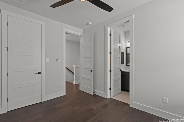 unfurnished bedroom with ensuite bathroom, ceiling fan, and dark hardwood / wood-style floors