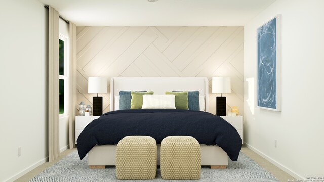 bedroom featuring light carpet and wooden walls