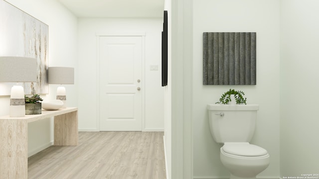 bathroom with hardwood / wood-style floors, vanity, and toilet