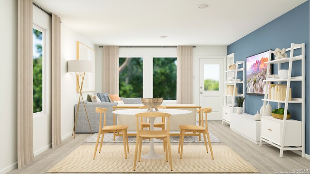 dining area with light wood-type flooring and a wealth of natural light