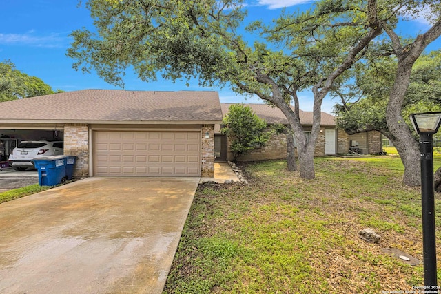 ranch-style home with a garage and a front yard