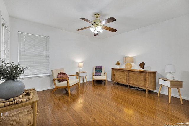 living area with hardwood / wood-style flooring and ceiling fan