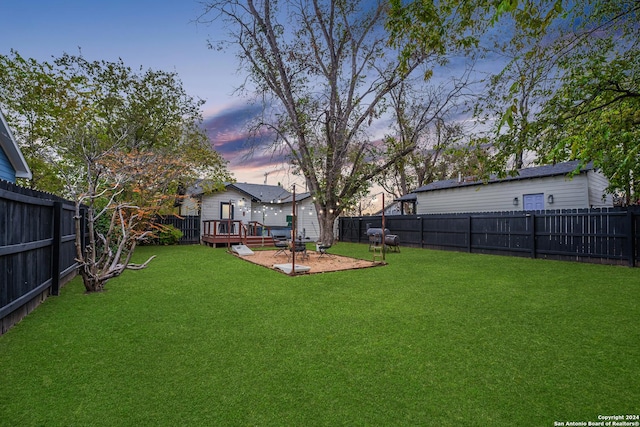 yard at dusk with a deck