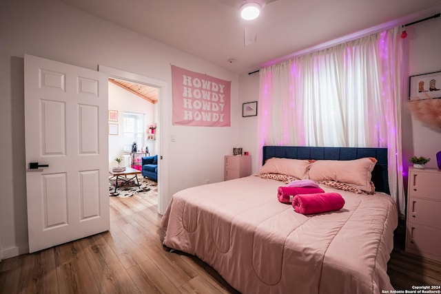 bedroom with light hardwood / wood-style flooring and vaulted ceiling