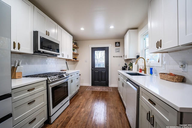 kitchen with white cabinets, stainless steel appliances, dark hardwood / wood-style floors, and sink