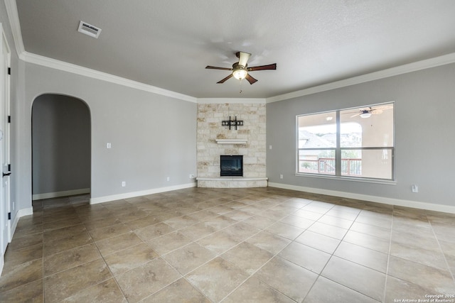 unfurnished living room with a fireplace, ornamental molding, ceiling fan, and light tile patterned floors