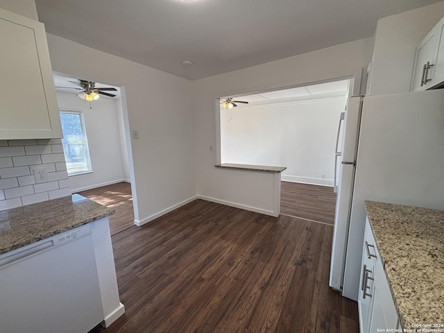 unfurnished dining area with ceiling fan and dark hardwood / wood-style flooring