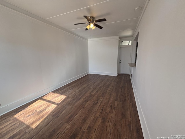 unfurnished room with ceiling fan, ornamental molding, and dark wood-type flooring