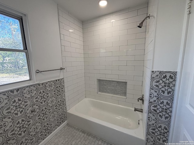 bathroom with tile patterned flooring and tiled shower / bath