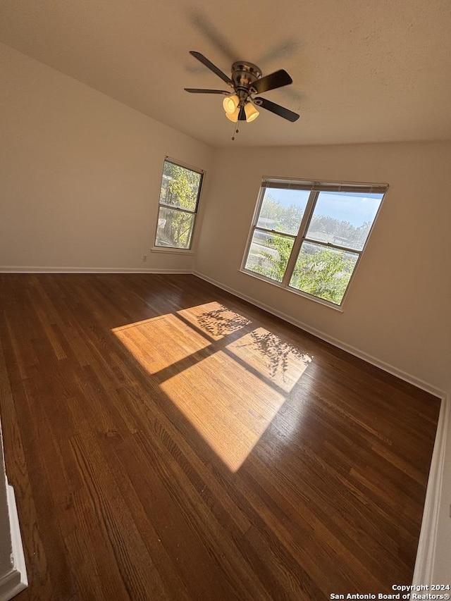 unfurnished room featuring dark hardwood / wood-style floors and ceiling fan