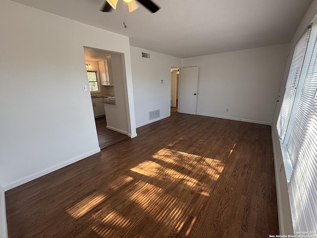 unfurnished bedroom featuring a closet, dark hardwood / wood-style floors, and ceiling fan