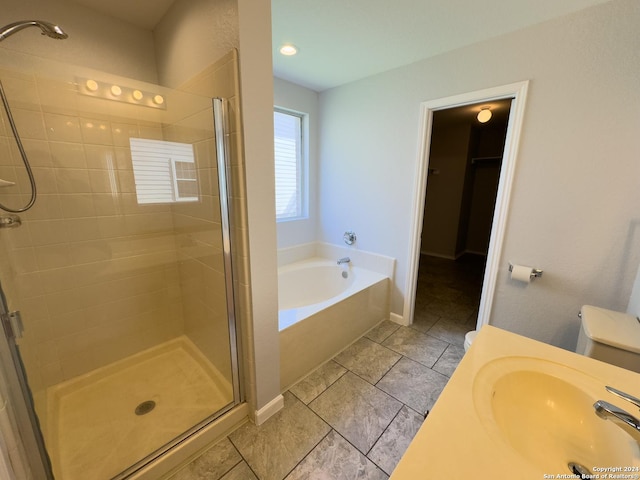 full bathroom with separate shower and tub, sink, and toilet